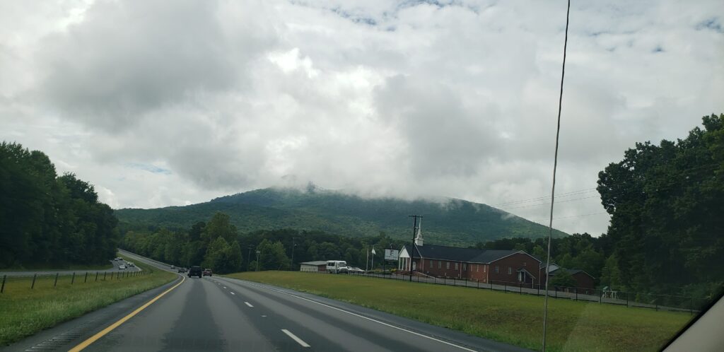 View of a mountain while driving on a highway